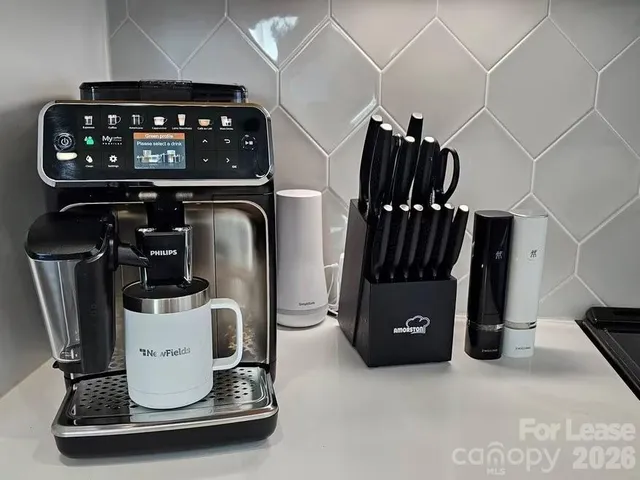 a dining room with furniture and a floor to ceiling window