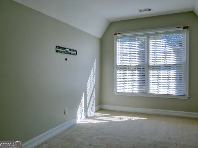 a room with walk in closet and window