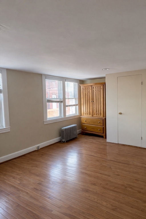 10 Orange Street, Unit 2 Chelsea, MA 02150 - Photo 13 of 17 an empty room with wooden floor and windows