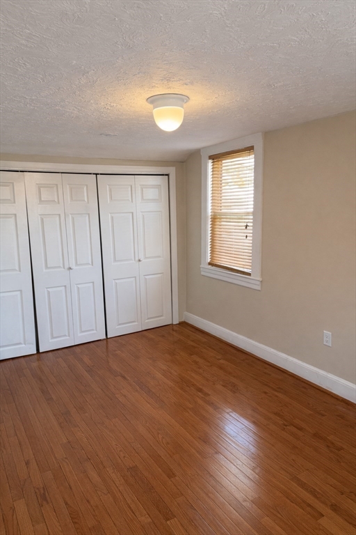 10 Orange Street, Unit 2 Chelsea, MA 02150 - Photo 15 of 17 a view of an empty room with wooden floor and a window