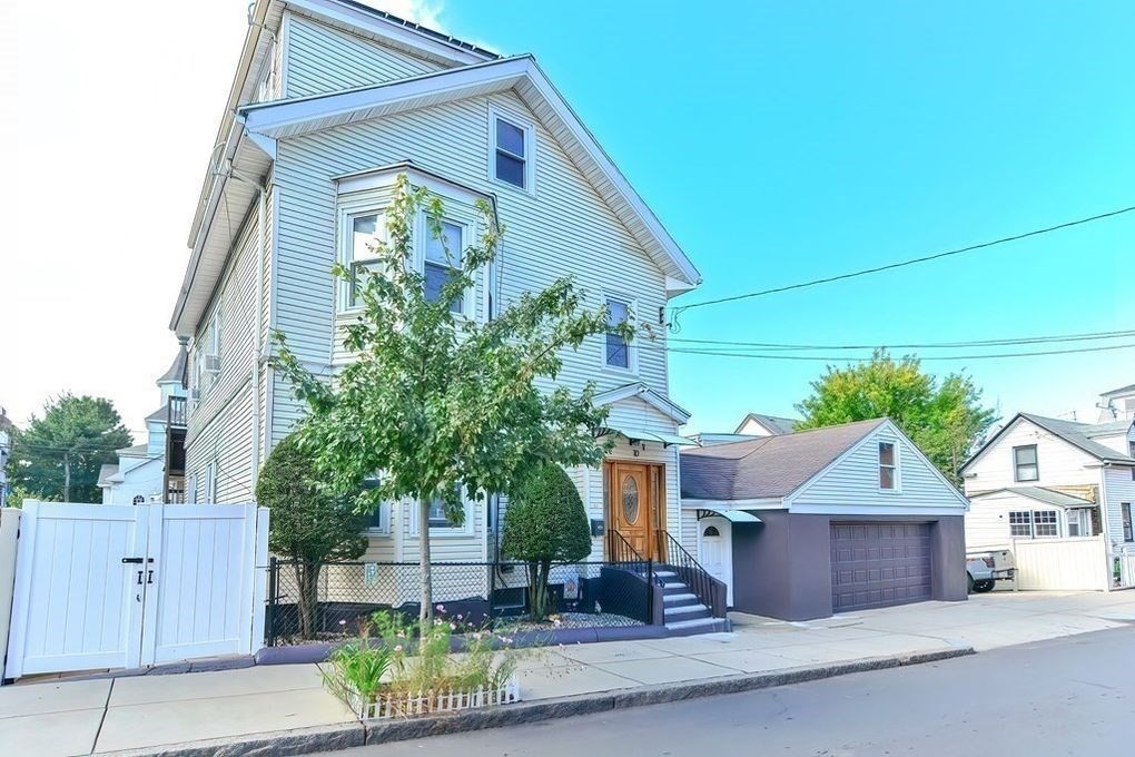 10 Orange Street, Unit 2 Chelsea, MA 02150 - Photo 2 of 17 a front view of a house with a garden