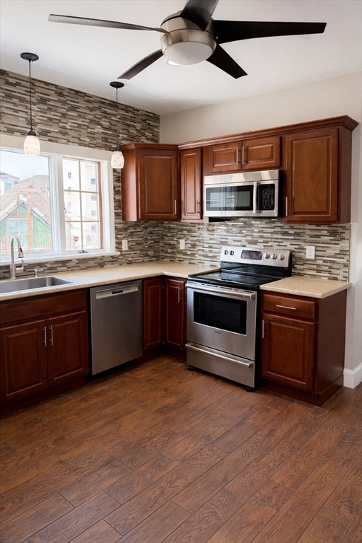 10 Orange Street, Unit 2 Chelsea, MA 02150 - Photo 4 of 17 a kitchen with stainless steel appliances granite countertop a stove a sink and a microwave