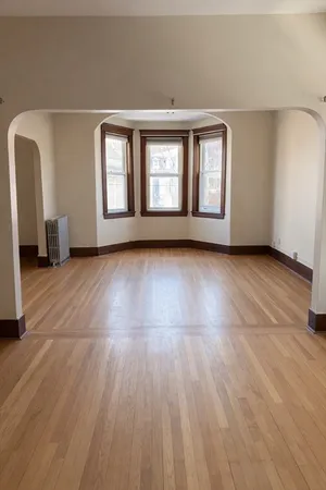 a view of an empty room with glass door and windows