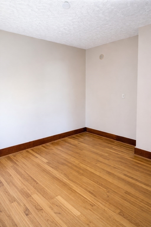 10 Orange Street, Unit 2 Chelsea, MA 02150 - Photo 9 of 17 a view of an empty room with wooden floor