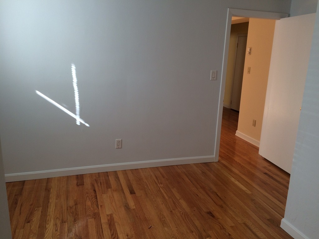 149 Winthrop Road, Unit 1 Brookline, MA 02445 - Photo 11 of 21 a view of an empty room with wooden floor