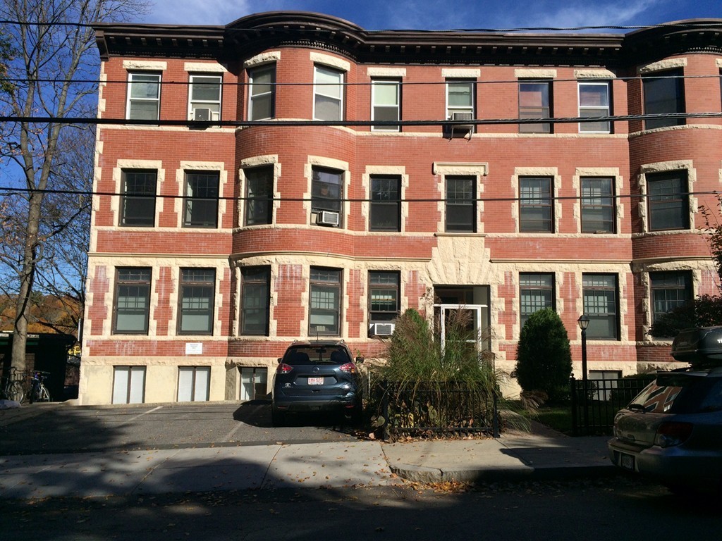 149 Winthrop Road, Unit 1 Brookline, MA 02445 - Photo 17 of 21 a front view of a building with lot of windows