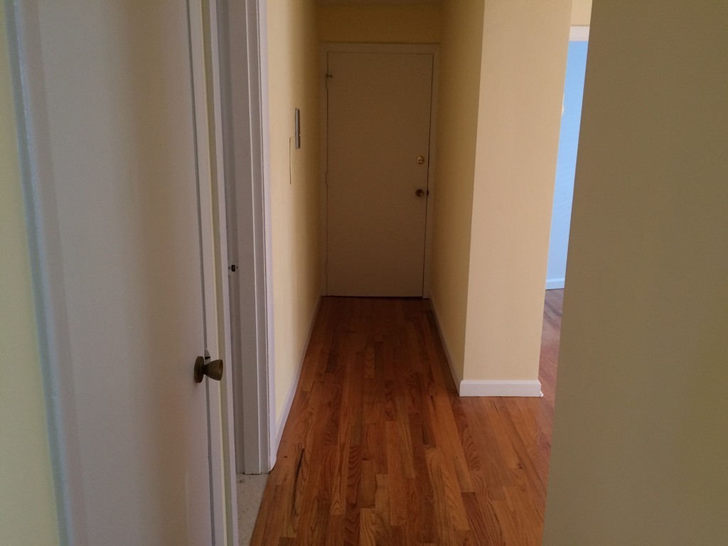 149 Winthrop Road, Unit 1 Brookline, MA 02445 - Photo 7 of 21 a view of a hallway with wooden floor