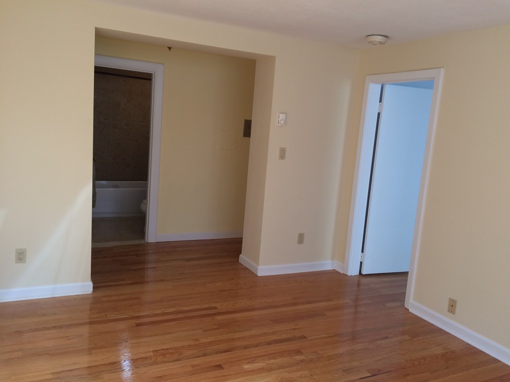 149 Winthrop Road, Unit 1 Brookline, MA 02445 - Photo 9 of 21 a view of an empty room with wooden floor