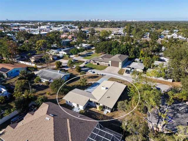 an aerial view of a residential houses with city view