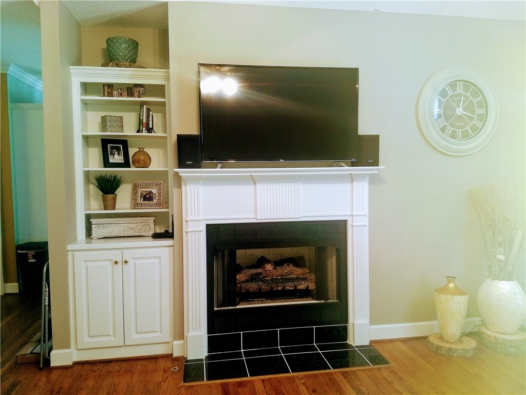 123 Charping Lane Anderson, SC 29621 - Photo 13 of 42 Living room with gas fireplace and built in booksh