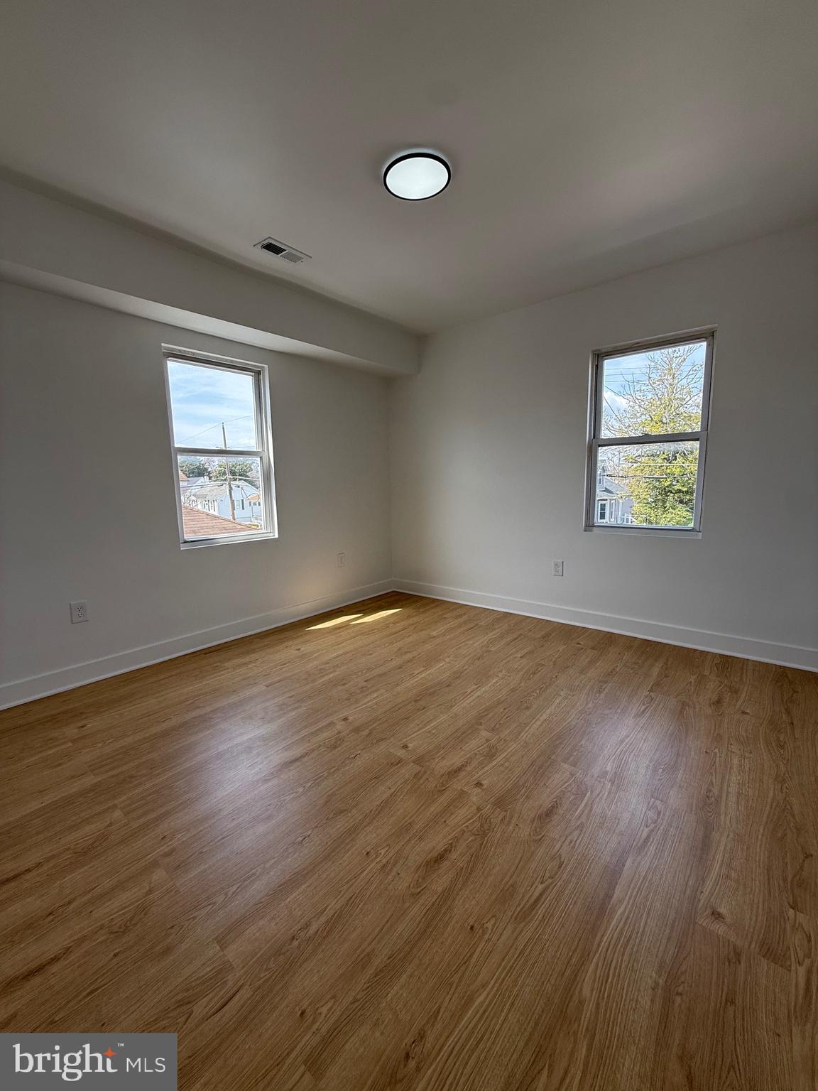 2125 Oakland Road Middle River, MD 21220 - Photo 13 of 15 a view of an empty room with wooden floor and a window