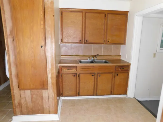 a view of a kitchen with wooden floor