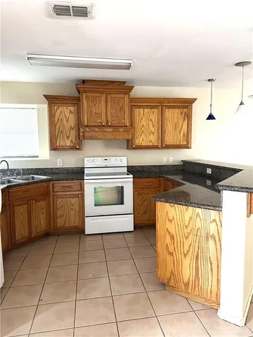 a kitchen with stainless steel appliances granite countertop a sink and a stove