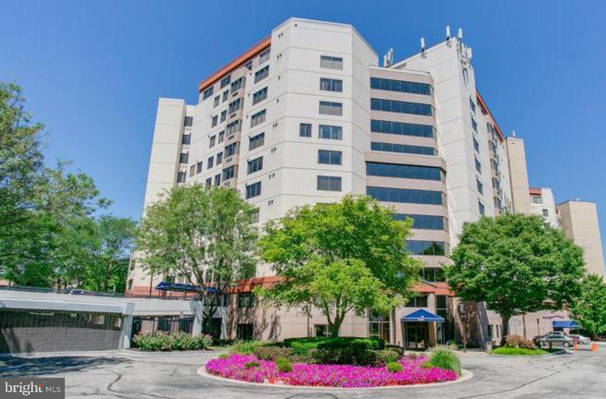 10001 Windstream Drive, Unit 404 Columbia, MD 21044 - Photo 1 of 29 a front view of multi story residential apartment building with yard