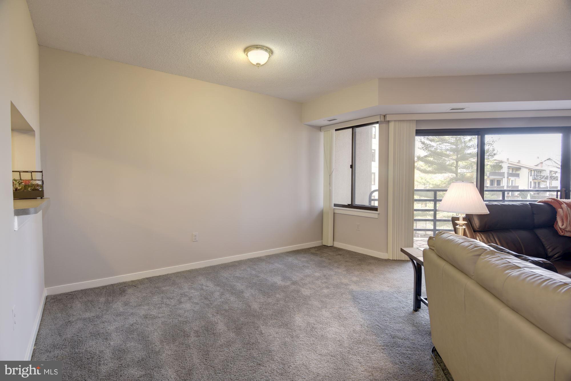 10001 Windstream Drive, Unit 404 Columbia, MD 21044 - Photo 11 of 29 a living room with furniture and a large window