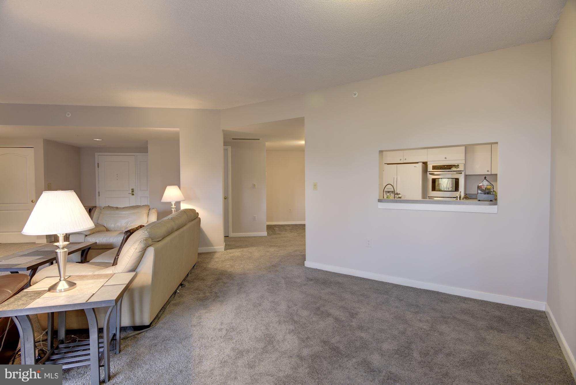 10001 Windstream Drive, Unit 404 Columbia, MD 21044 - Photo 12 of 29 a bed room with a bed and a chair