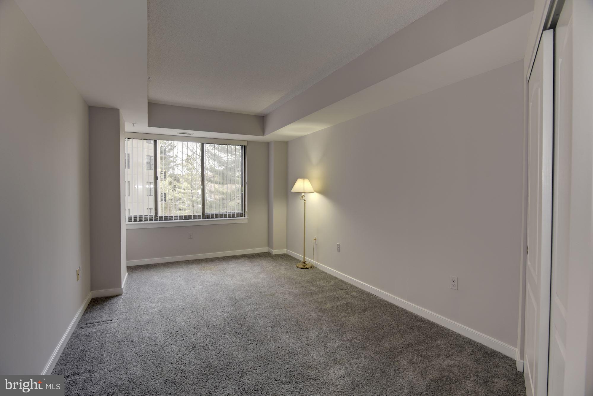 10001 Windstream Drive, Unit 404 Columbia, MD 21044 - Photo 17 of 29 an empty room with windows and closet