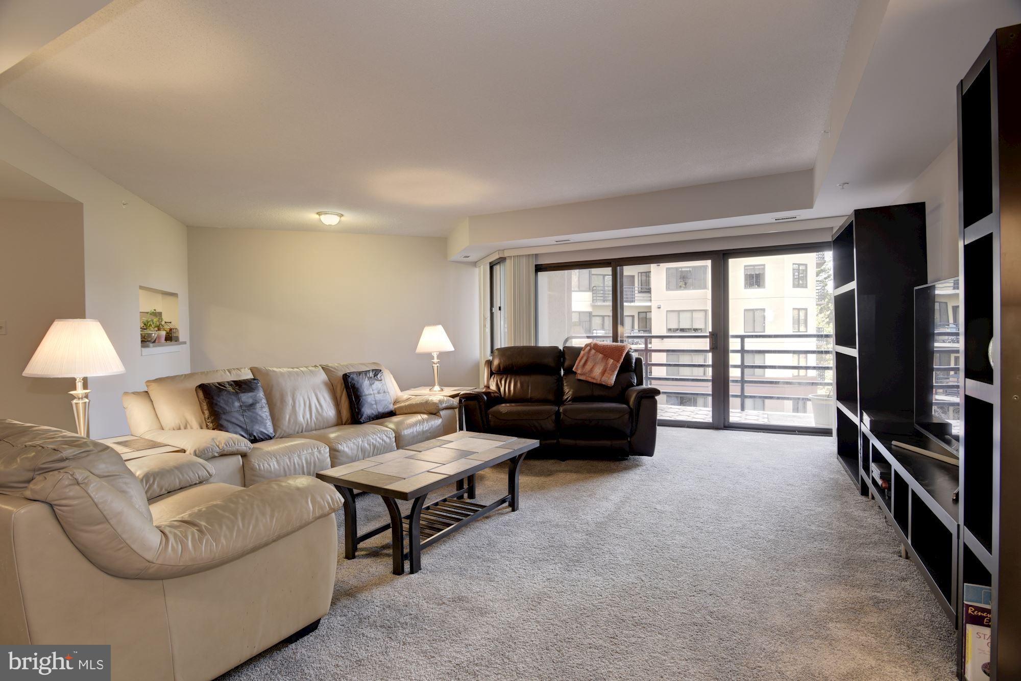 10001 Windstream Drive, Unit 404 Columbia, MD 21044 - Photo 3 of 29 a living room with furniture and a flat screen tv