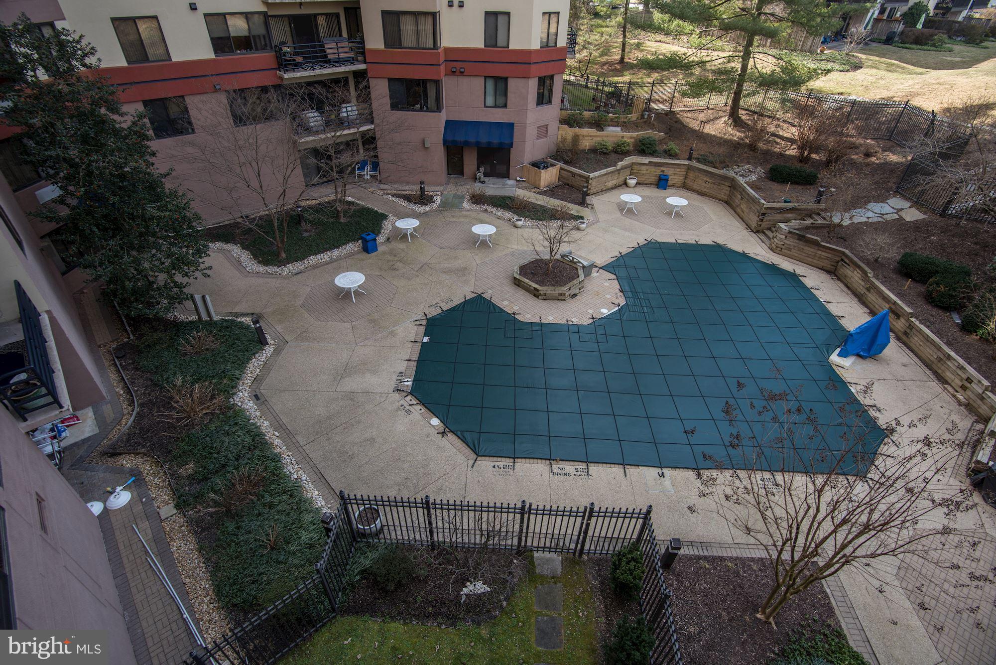 10001 Windstream Drive, Unit 404 Columbia, MD 21044 - Photo 23 of 29 a picture of table and chairs with wooden fence