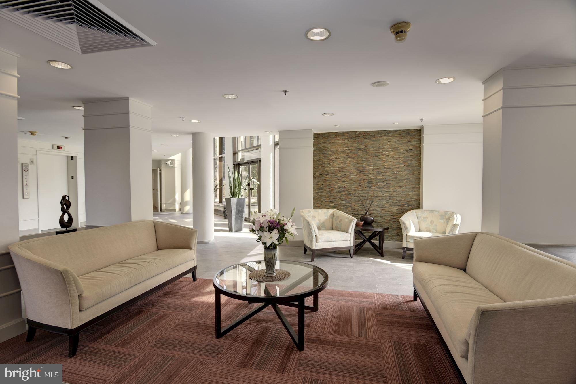 10001 Windstream Drive, Unit 404 Columbia, MD 21044 - Photo 26 of 29 a living room with furniture and a couch