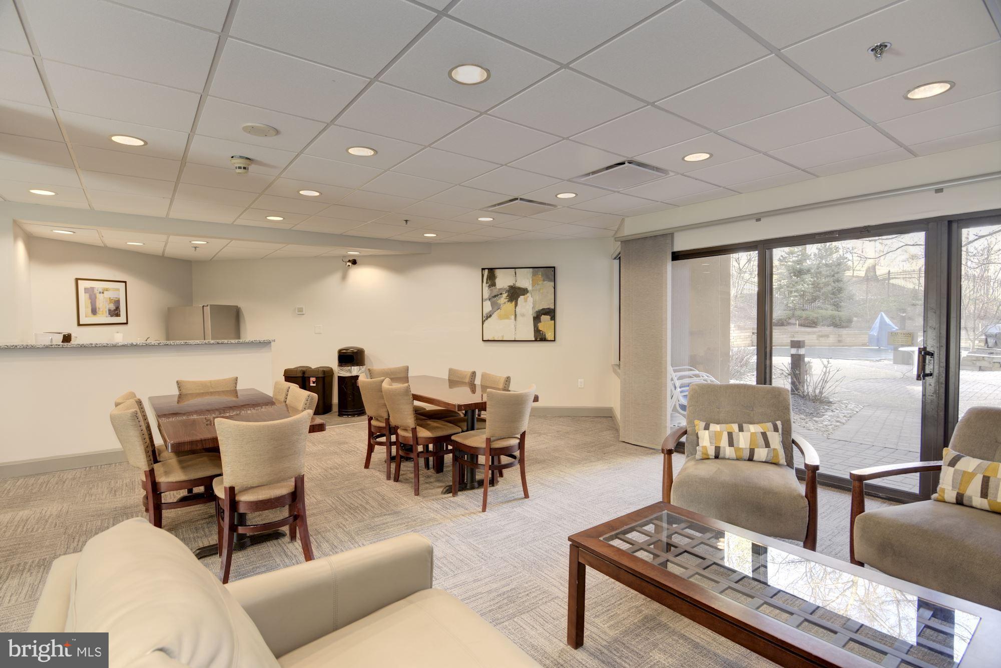 10001 Windstream Drive, Unit 404 Columbia, MD 21044 - Photo 27 of 29 a living room with furniture and a large window