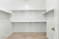 3618 East Roland Street Mesa, AZ 85213 - Photo 13 of 26 a view of an empty walk in closet