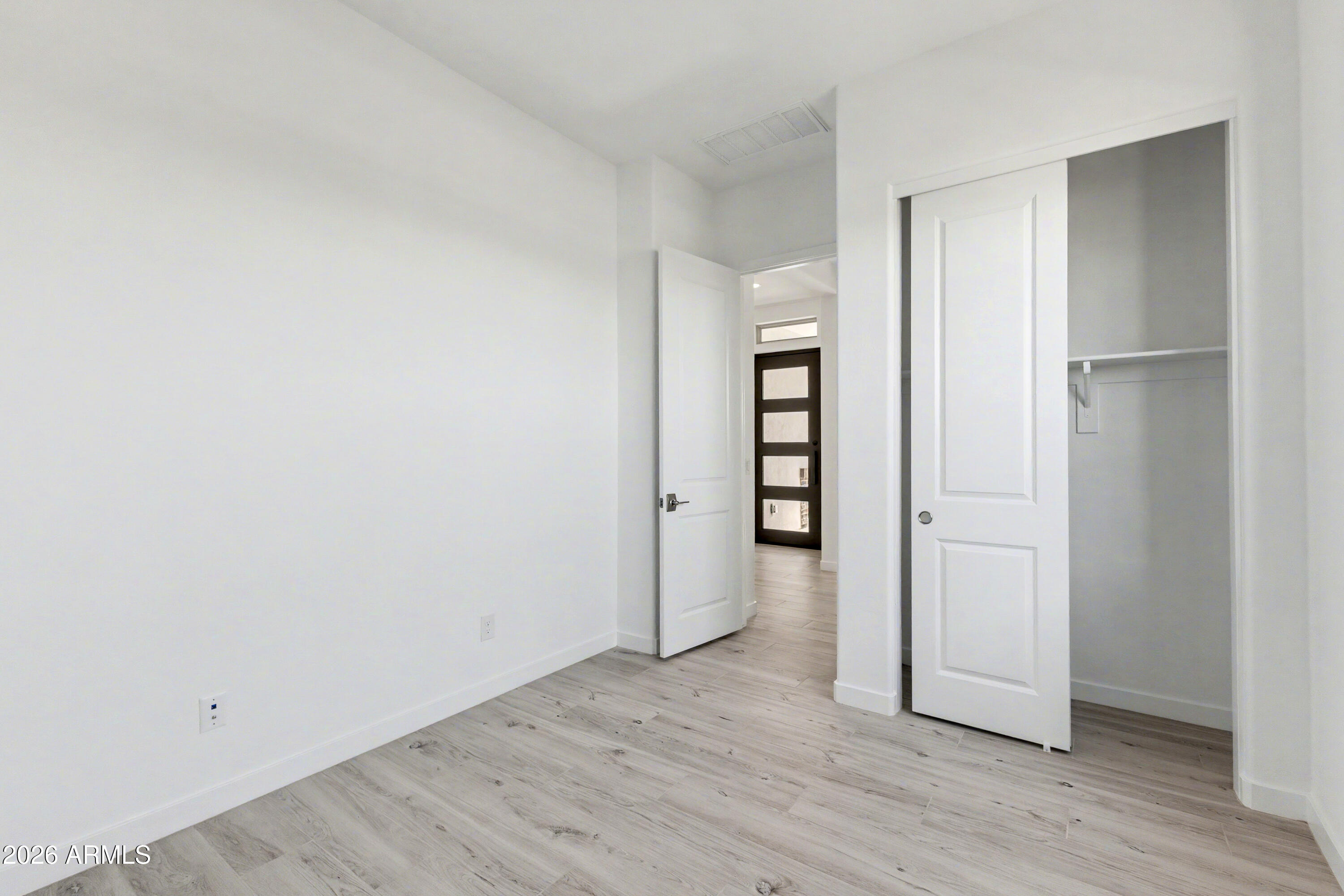 3618 East Roland Street Mesa, AZ 85213 - Photo 18 of 26 an empty room with wooden floor