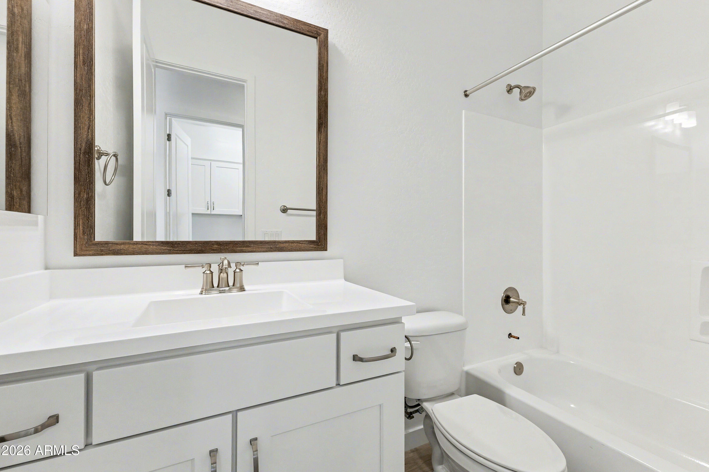 3618 East Roland Street Mesa, AZ 85213 - Photo 23 of 26 a bathroom with a sink toilet vanity and shower