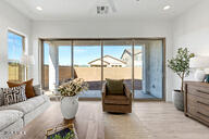 3618 East Roland Street Mesa, AZ 85213 - Photo 24 of 26 a living room with furniture and a potted plant