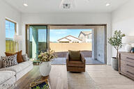 3618 East Roland Street Mesa, AZ 85213 - Photo 25 of 26 a living room with furniture and a large window