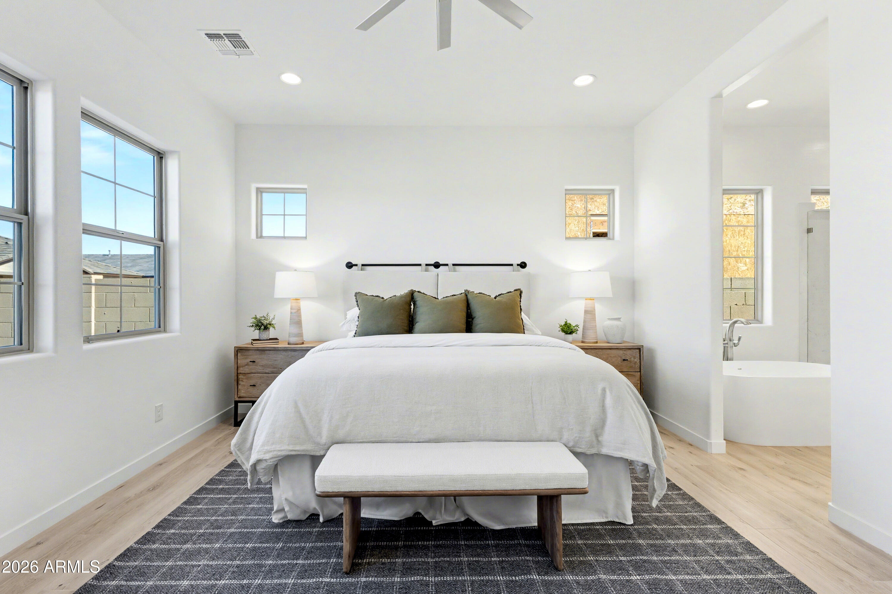 3618 East Roland Street Mesa, AZ 85213 - Photo 9 of 26 a bedroom with a bed and wooden floor