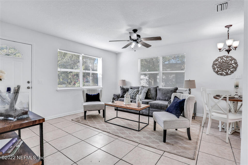 4657 Colchester Road Jacksonville, FL 32208 - Photo 11 of 23 a living room with furniture a chandelier and a window