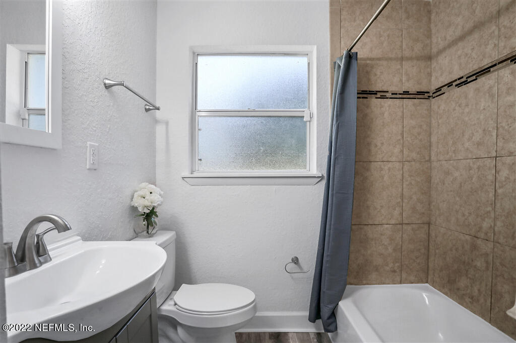 4657 Colchester Road Jacksonville, FL 32208 - Photo 12 of 23 a bathroom with a sink toilet and shower