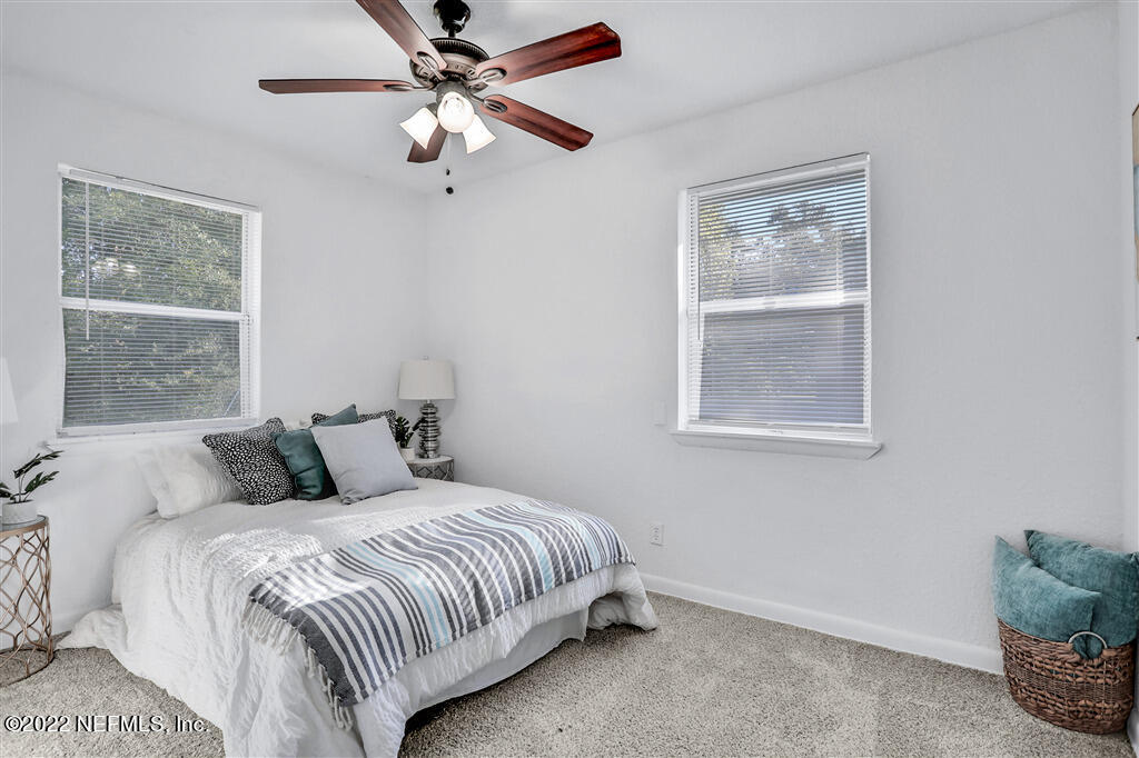 4657 Colchester Road Jacksonville, FL 32208 - Photo 13 of 23 a bedroom with a large bed and a window