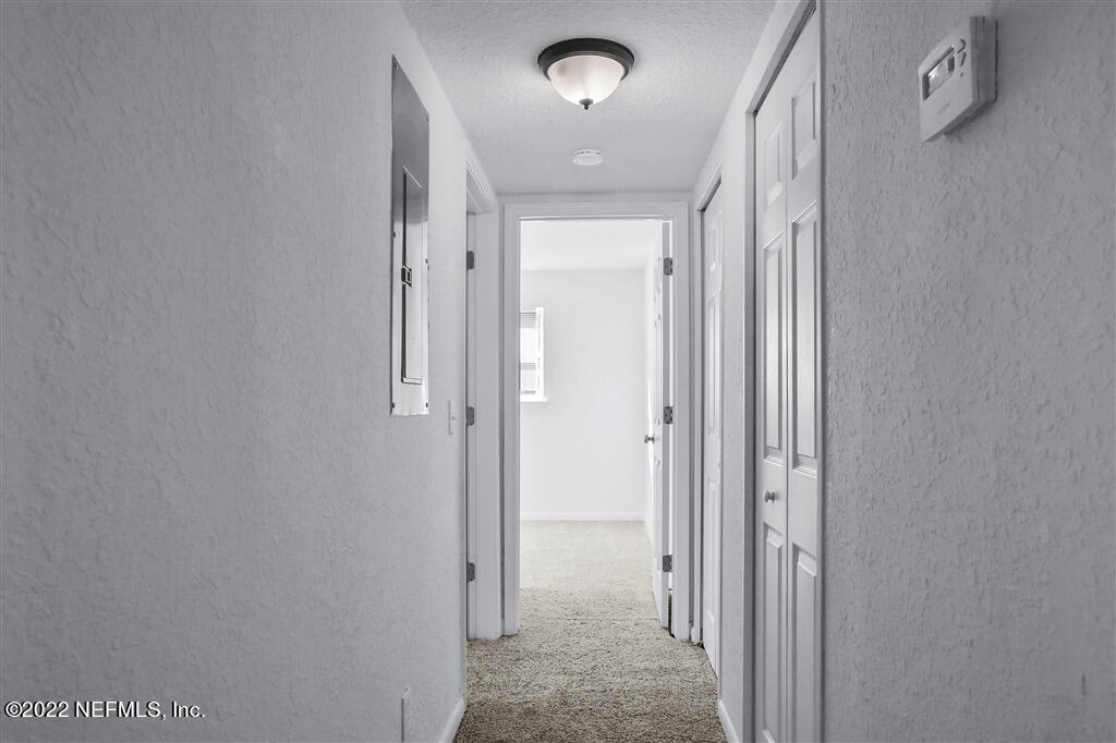 4657 Colchester Road Jacksonville, FL 32208 - Photo 18 of 23 a view of a hallway with wooden floor