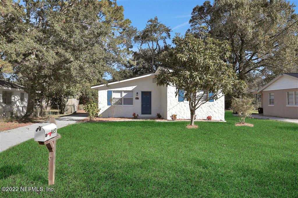 4657 Colchester Road Jacksonville, FL 32208 - Photo 3 of 23 a view of a yard with a house and garden