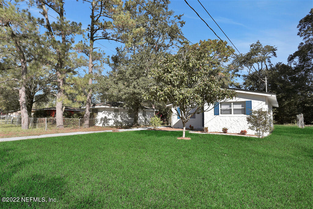 4657 Colchester Road Jacksonville, FL 32208 - Photo 4 of 23 a front view of a house with a garden