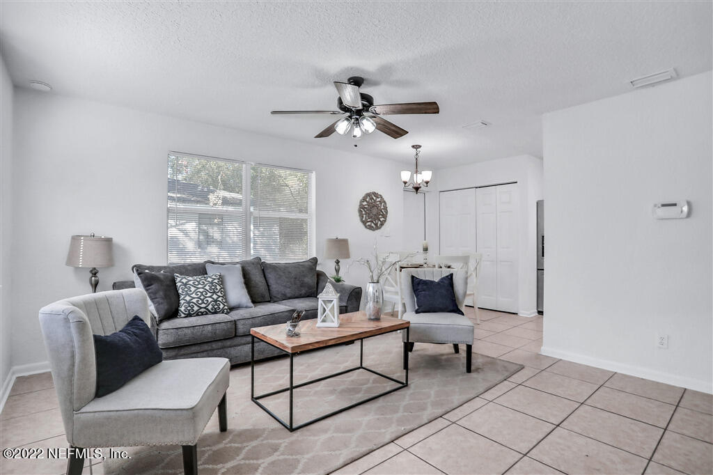 4657 Colchester Road Jacksonville, FL 32208 - Photo 6 of 23 a living room with furniture and a chandelier