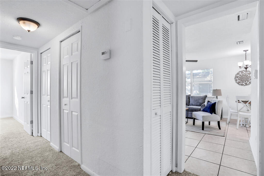 4657 Colchester Road Jacksonville, FL 32208 - Photo 8 of 23 a view of a hallway with living room and furniture