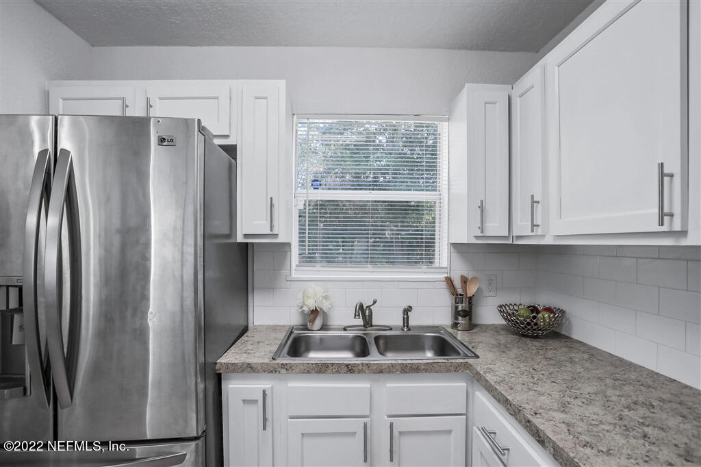 4657 Colchester Road Jacksonville, FL 32208 - Photo 10 of 23 a kitchen with stainless steel appliances granite countertop a refrigerator sink and cabinets