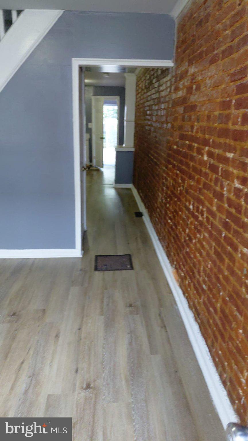 2121 Wilhelm Street Baltimore, MD 21223 - Photo 10 of 13 Charming hallway with exposed brick.