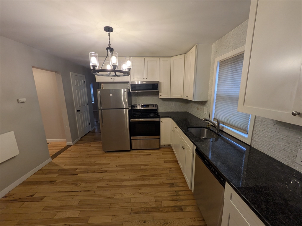 1640 Westover Road Chicopee, MA 01020 - Photo 2 of 20 a kitchen with stainless steel appliances granite countertop a sink stove and refrigerator