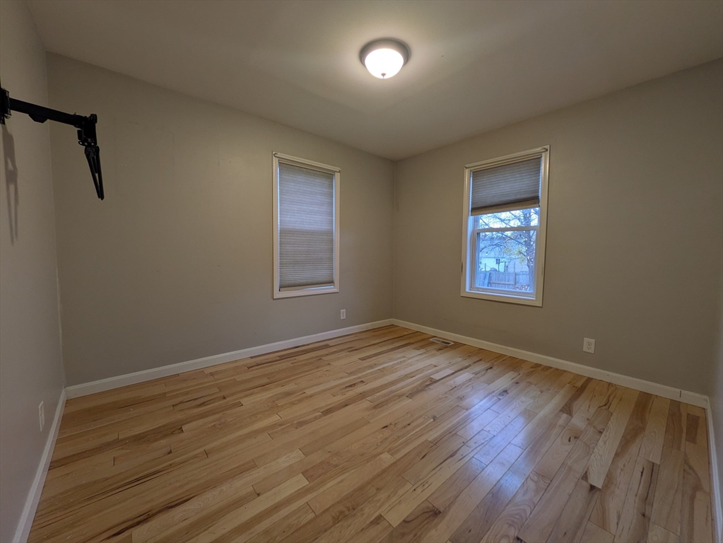 1640 Westover Road Chicopee, MA 01020 - Photo 8 of 20 a view of an empty room with wooden floor and a window