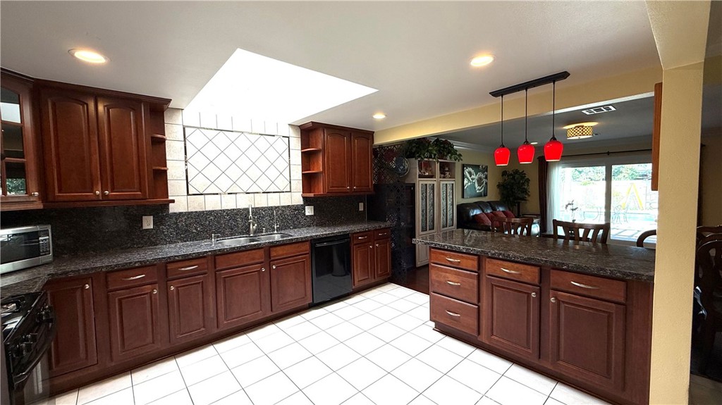 230 San Antonio Road Arcadia, CA 91007 - Photo 9 of 19 a kitchen with stainless steel appliances granite countertop wooden cabinets and a sink