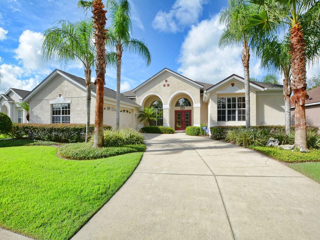9064 Laurel Ridge Drive Mount Dora, FL 32757 - Photo 1 of 1 a front view of a house with a garden