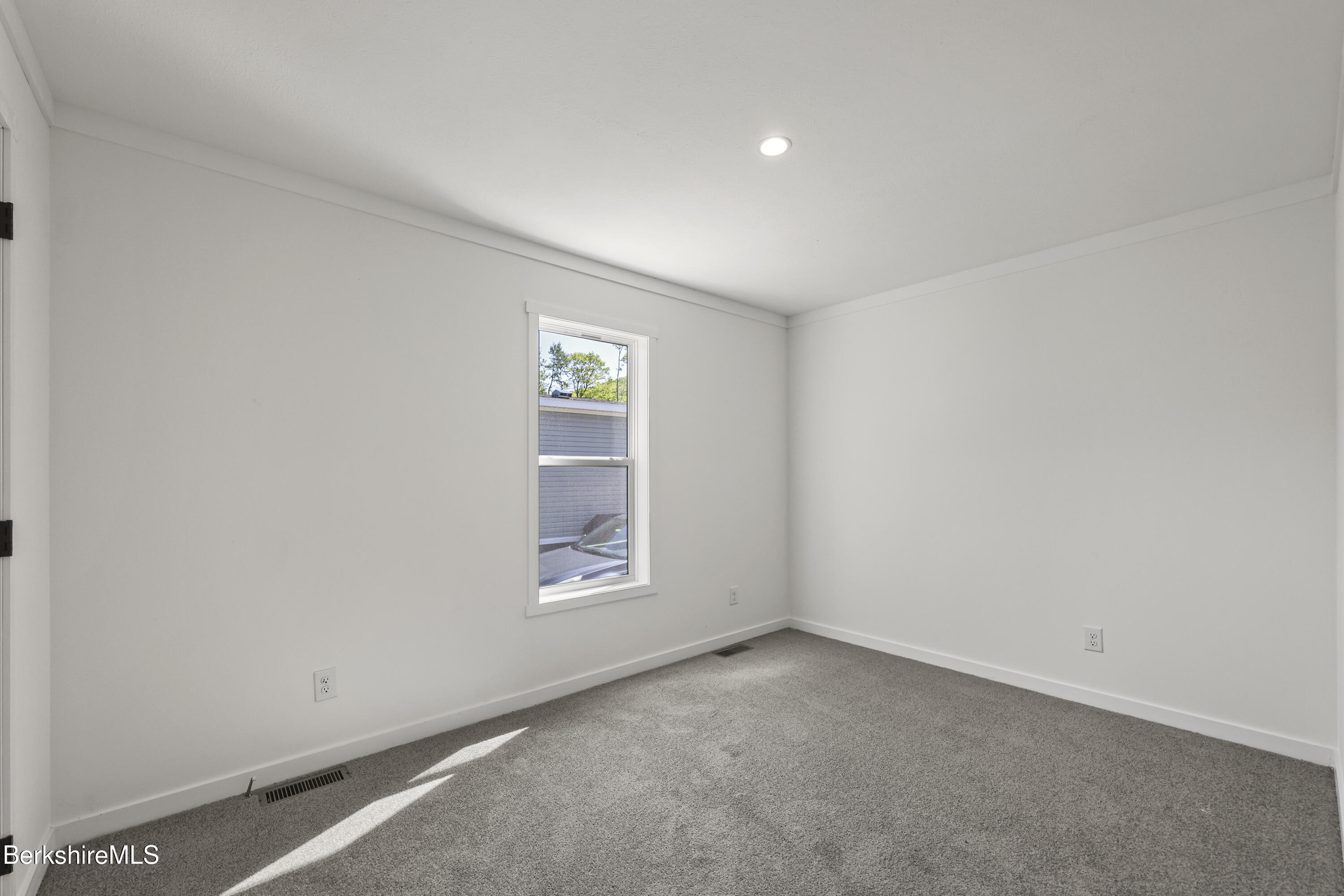 395 Cheshire Road, Unit 102 Pittsfield, MA 01201 - Photo 24 of 28 an empty room with windows