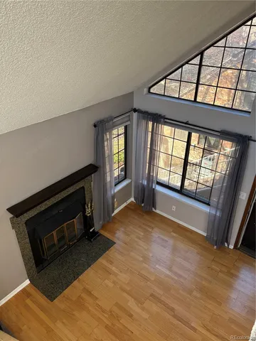 a view of an empty room with glass door and windows