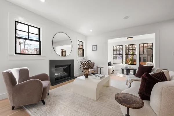 a view of a a dining room with furniture window and wooden floor