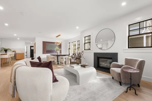 a living room with furniture and wall paintings