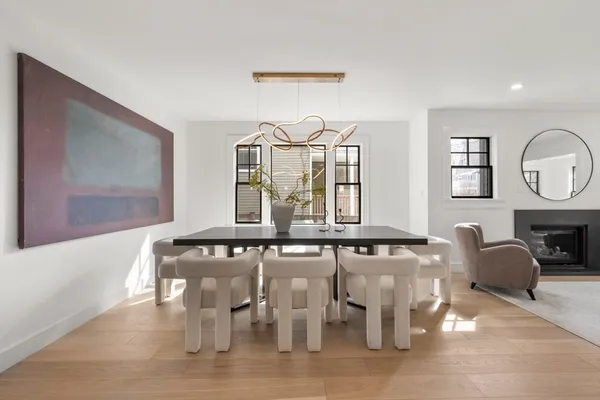 a view of a patio with couches table and chairs and potted plants